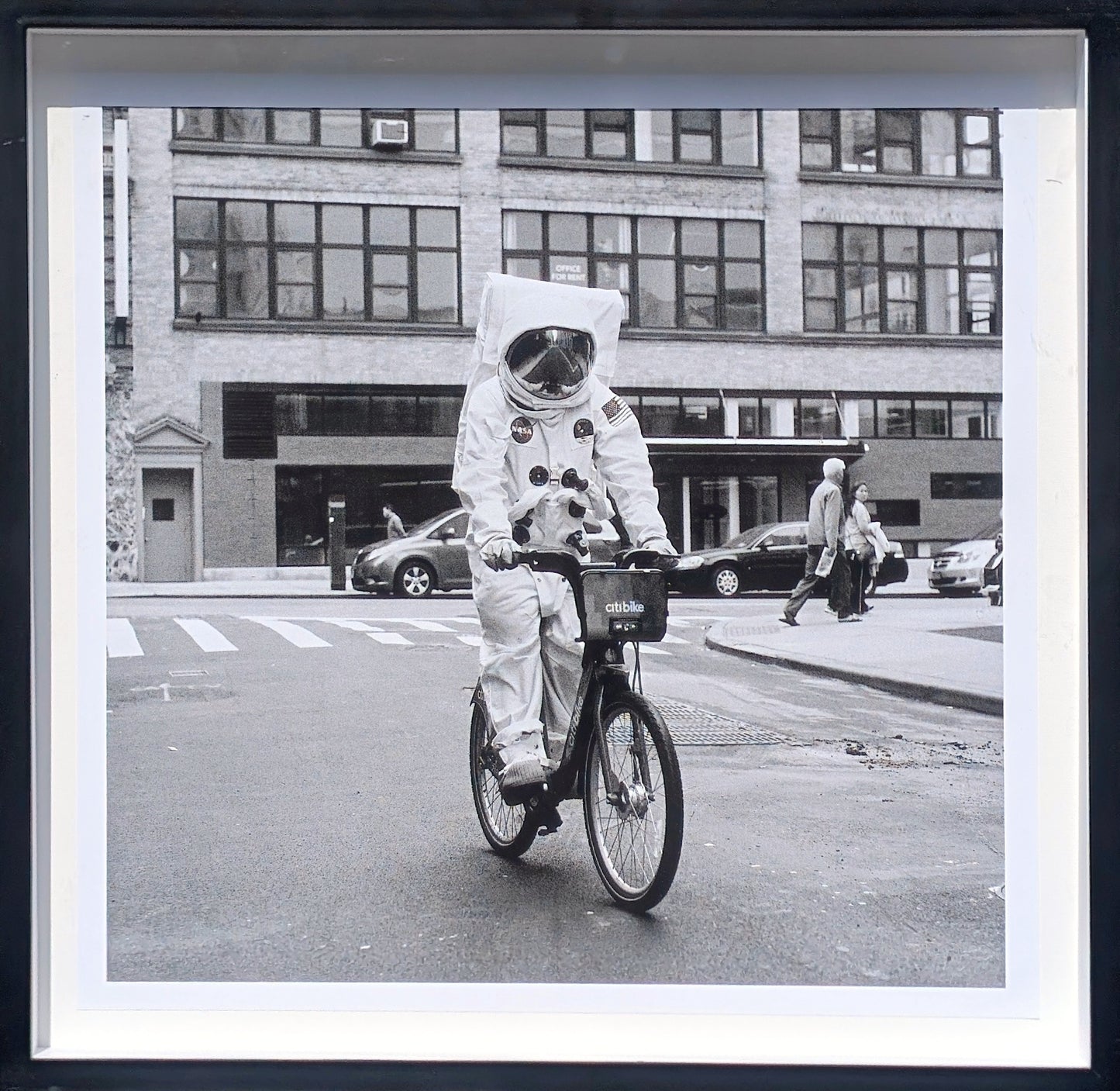 ANDY BLANK, "Space Race" Contemporary Black and White Photograph of an Astronaut Riding a Bike