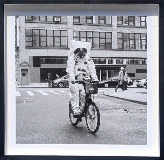 ANDY BLANK, "Space Race" Contemporary Black and White Photograph of an Astronaut Riding a Bike